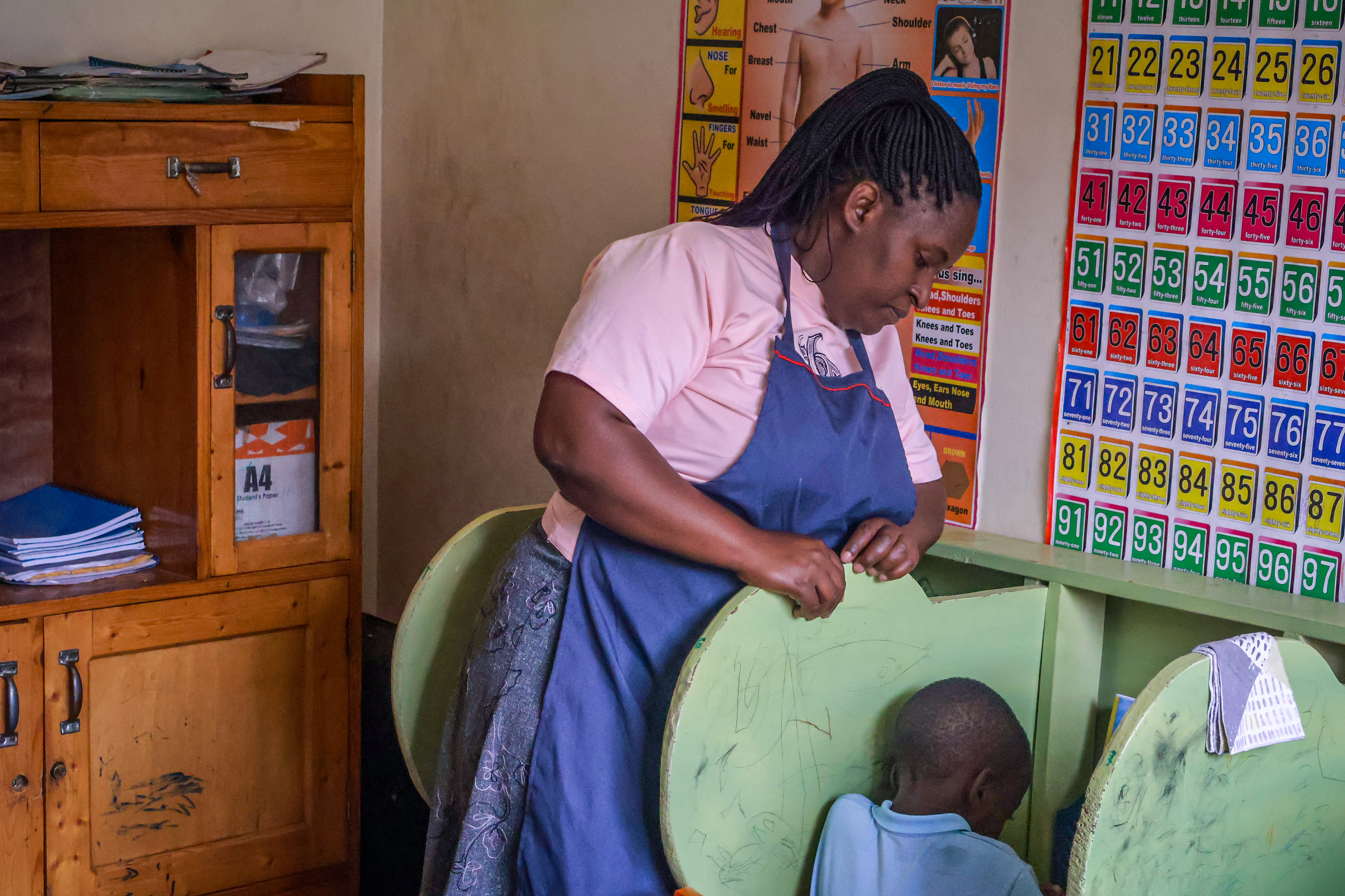 Teacher giving one-on-one attention to a learner in the classroom